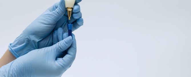 Dentist in Woodbridge VA placing a dental implant to replace a missing tooth and restore a patient’s smile